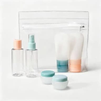 Clear zipper pouch behind two squeeze bottles, a spray bottle, a flip-cap bottle, and two cream jars with teal and peach caps