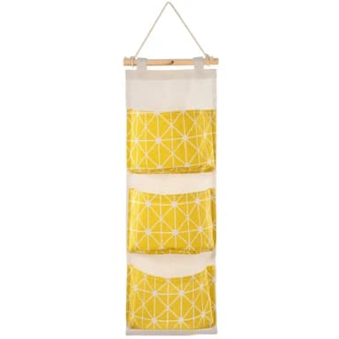 Empty yellow three-pocket fabric wall organizer hanging from a wooden rod and rope, on a white background