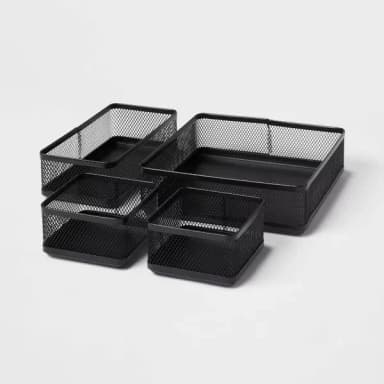 Four black mesh trays laid side by side: one large, one long, and two small, on a light gray background