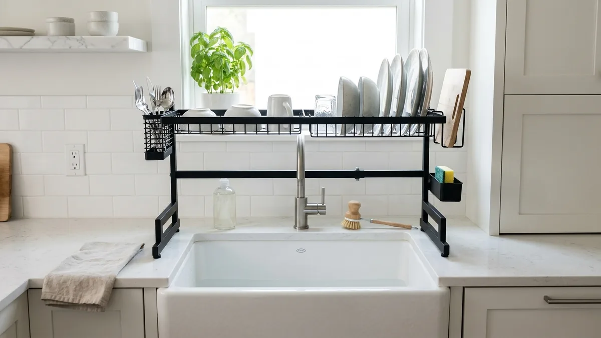 Adjustable-width over-the-sink dish rack with removable drip tray over a deep farmhouse kitchen sink