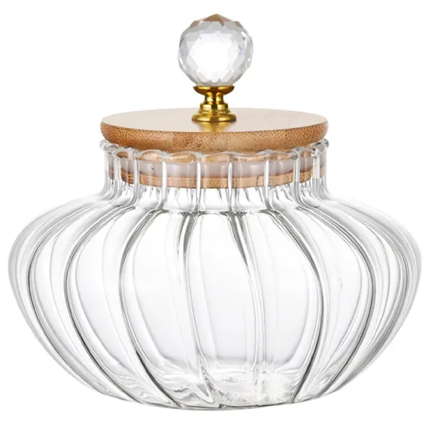 Ribbed glass storage jar with a wooden lid and a faceted clear knob, shown empty on a white background. Photo: Sesoris product catalog