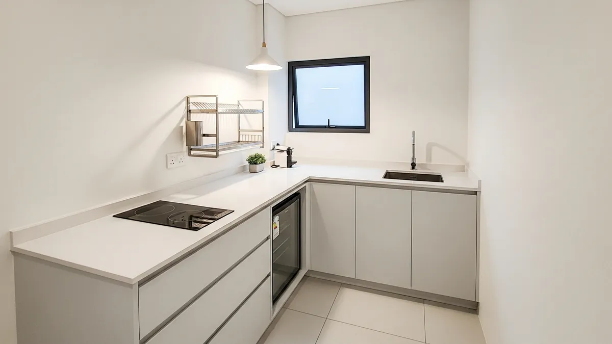Efficient L-shaped minimalist kitchen layout for small Indonesian home with smart storage solutions