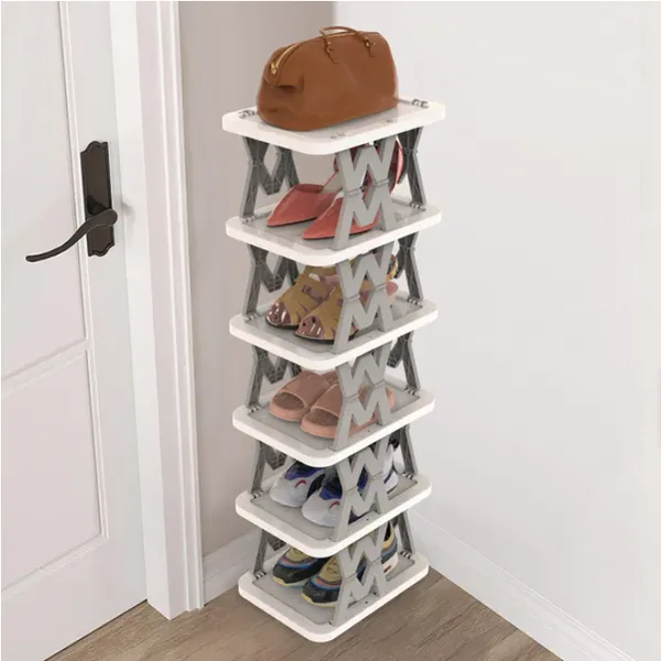 White six-tier foldable narrow shoe rack with gray folding side frames, standing beside a door with shoes and a bag on it. Photo: Sesoris product catalog